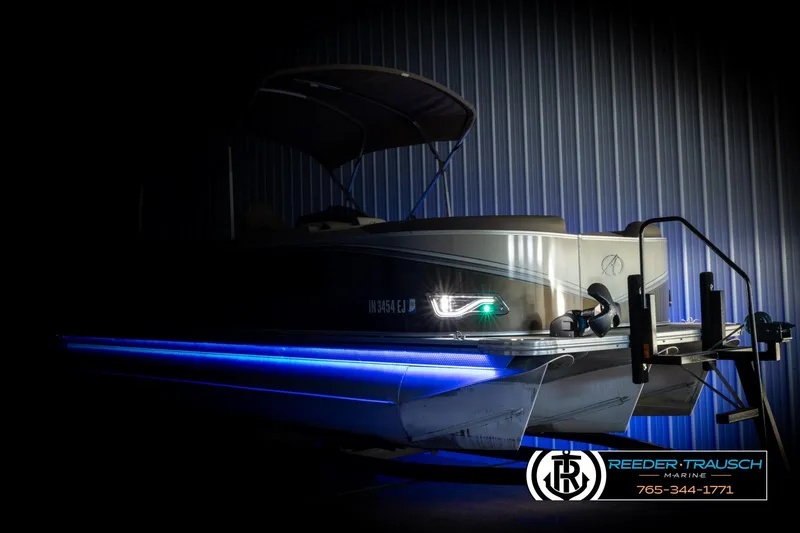 Slide: The Image of 2022 Avalon LSZ QL boat with blue LED lights in a dimly lit setting. - 4