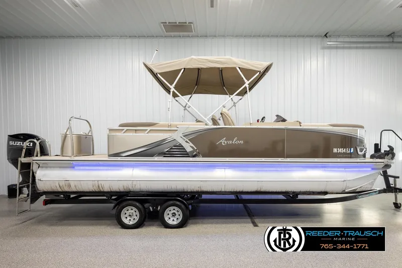 Slide: The Image of 2022 Avalon LSZ QL pontoon boat with canopy and Suzuki motor in showroom. - 5