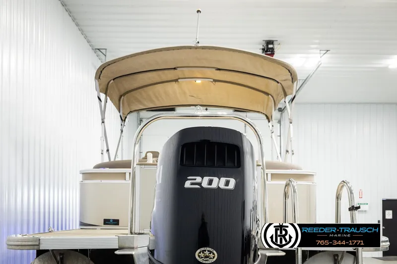 Slide: The Image of 2022 Avalon LSZ QL pontoon boat with 200 HP engine in indoor storage. - 7