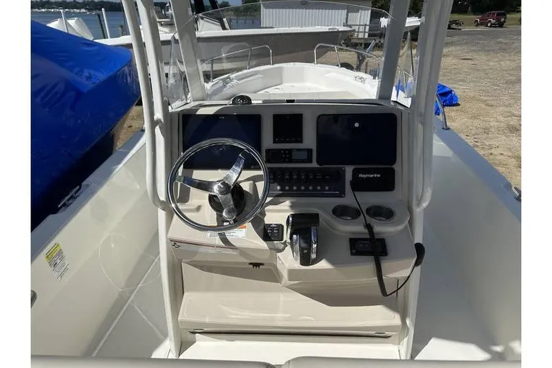 Slide: The Image of 2021 Boston Whaler 250 Dauntless boat console with steering wheel and controls. - 3