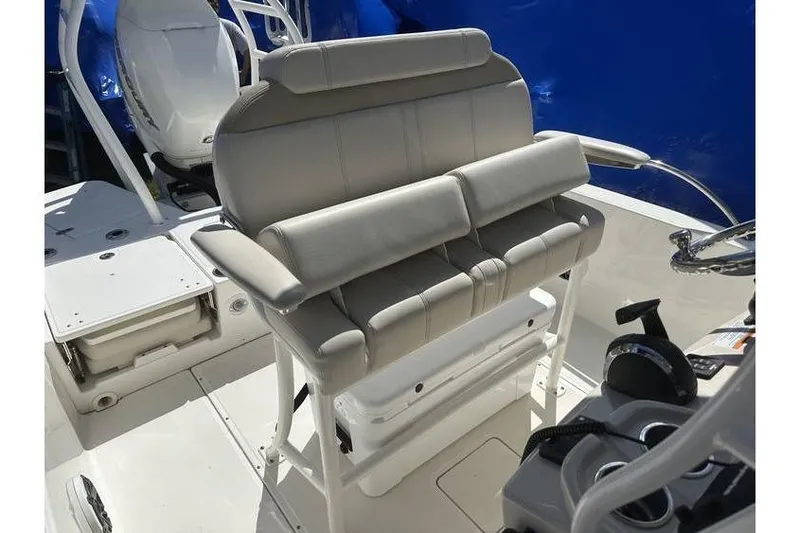 Slide: The Image of 2021 Boston Whaler 250 Dauntless boat interior with cushioned seating and control panel. - 7