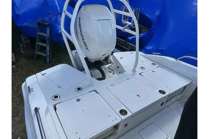 Slide: The Image of 2021 Boston Whaler 250 Dauntless boat with Mercury engine, white deck, and storage compartments. - 8