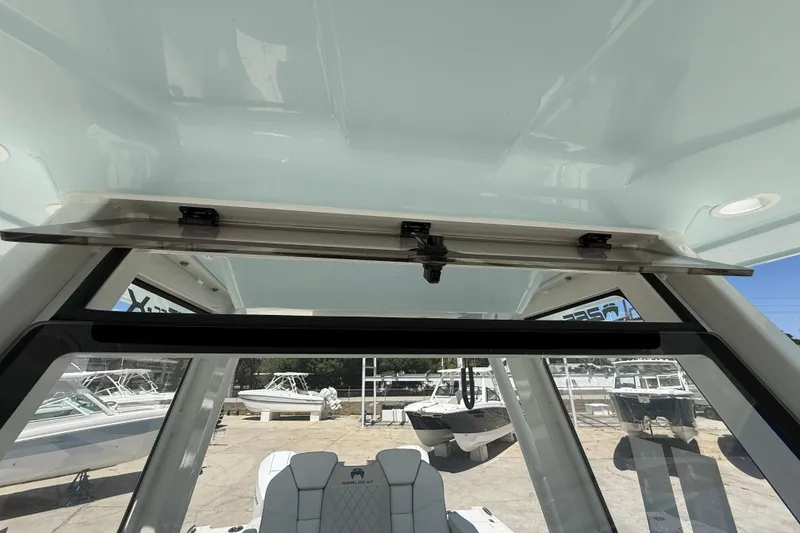 Slide: The Image of 2026 World Cat 265 CC-X boat interior with open hatch and seating view. - 12