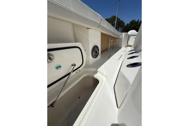 Slide: The Image of Interior view of 2026 World Cat 265 CC-X boat, featuring storage compartments and sleek design. - 13