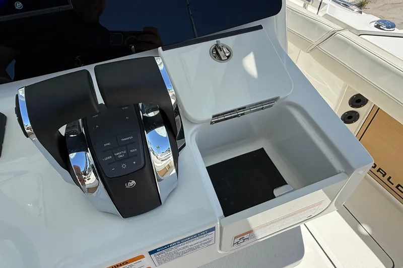 Slide: The Image of 2026 World Cat 265 CC-X boat console with modern controls and storage compartment. - 18