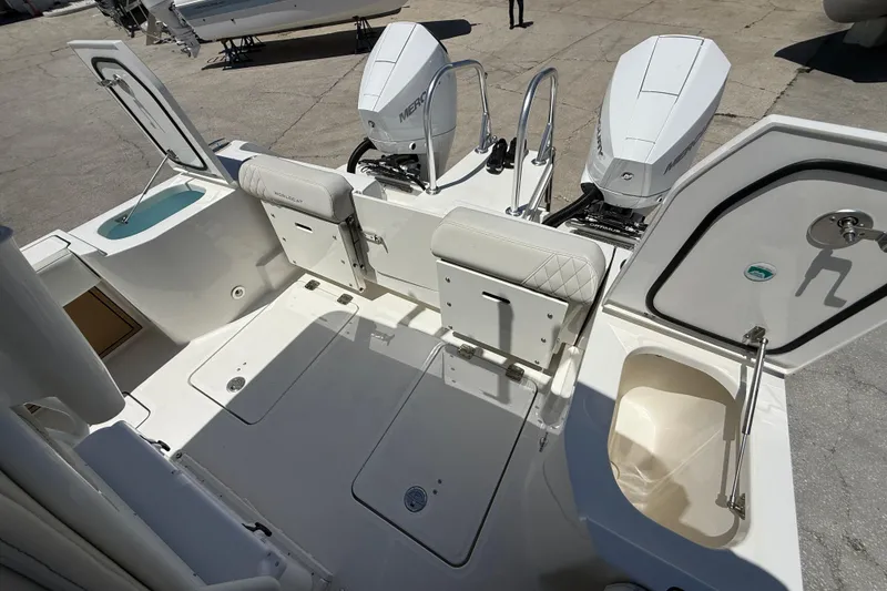 Slide: The Image of 2026 World Cat 265 CC-X boat deck with dual Mercury engines and storage compartments. - 20