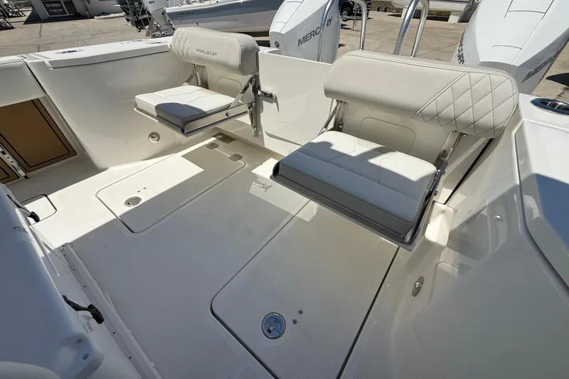 Slide: The Image of 2026 World Cat 265 CC-X boat interior with cushioned seating and storage compartments. - 21