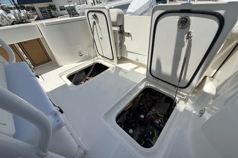 Slide: The Image of 2026 World Cat 265 CC-X boat deck with open storage compartments. - 22