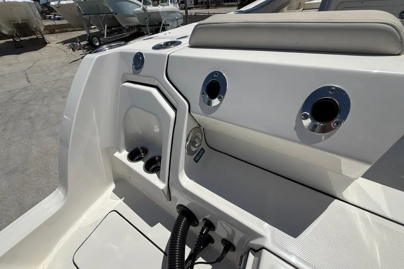 Slide: The Image of 2026 World Cat 265 CC-X boat interior with cup holders and chrome fittings. - 25