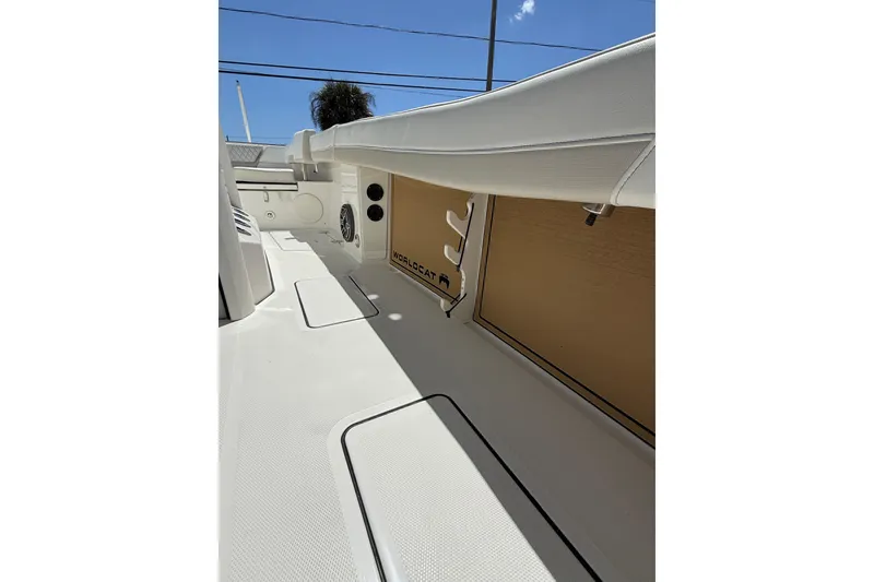 Slide: The Image of 2026 World Cat 265 CC-X boat interior with sleek white design and storage compartments. - 28