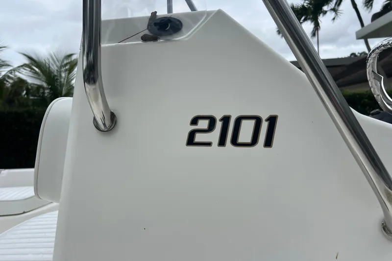 Slide: The Image of Close-up of 2005 Mako 2101 Inshore boat model number on white surface. - 11