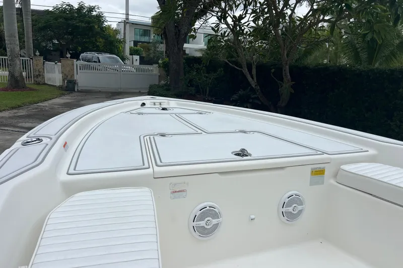Slide: The Image of 2005 Mako 2101 Inshore boat deck with storage compartments and speakers. - 12