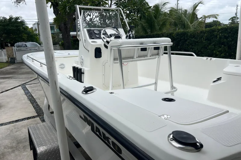 Slide: The Image of 2005 Mako 2101 Inshore boat with console and seating, parked on a trailer. - 14