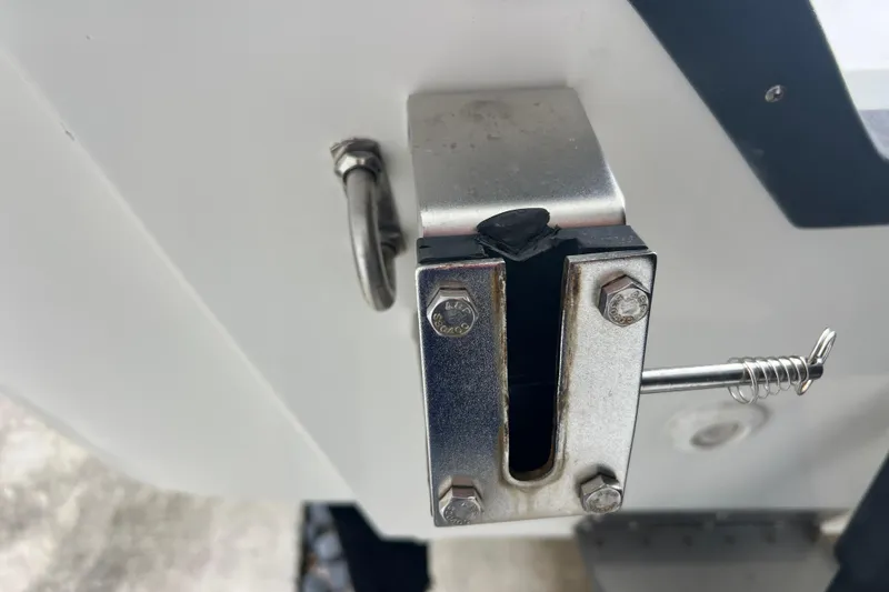 Slide: The Image of Close-up of a 2005 Mako 2101 Inshore boat's metal bracket and latch mechanism. - 15