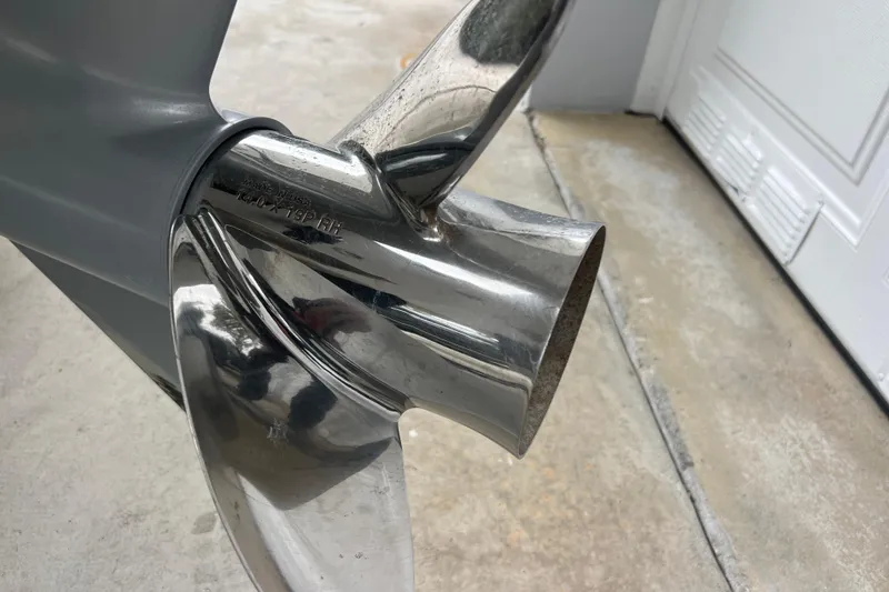 Slide: The Image of Close-up of a stainless steel boat propeller on a 2005 Mako 2101 Inshore. - 17