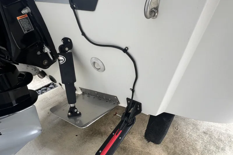 Slide: The Image of 2005 Mako 2101 Inshore boat transom with trim tab and hydraulic components. - 20