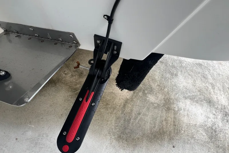 Slide: The Image of 2005 Mako 2101 Inshore boat with trim tab and transducer detail. - 22