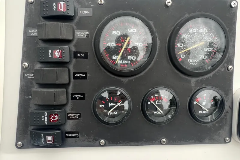 Slide: The Image of Dashboard of a 2005 Mako 2101 Inshore boat with gauges and switches. - 32