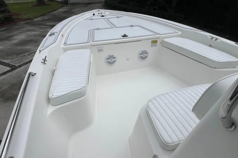 Slide: The Image of 2005 Mako 2101 Inshore boat interior with white seating and storage compartments. - 33