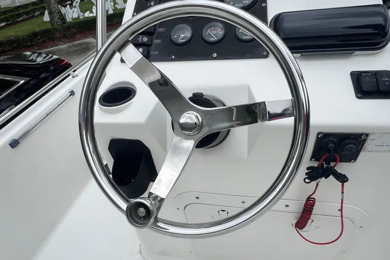 Slide: The Image of Steering wheel and dashboard of a 2005 Mako 2101 Inshore boat. - 41