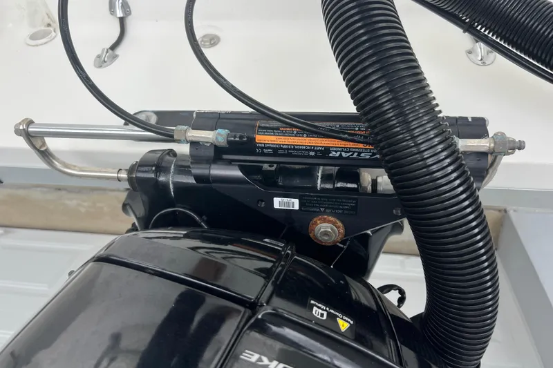 Slide: The Image of Close-up of 2005 Mako 2101 Inshore boat engine components and steering mechanism. - 44