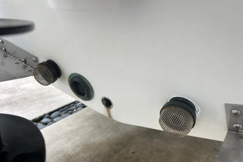 Slide: The Image of 2005 Mako 2101 Inshore boat hull with metal mesh drain covers. - 46