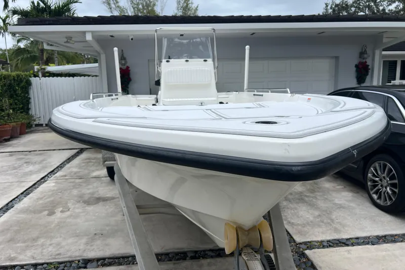 Slide: The Image of 2005 Mako 2101 Inshore boat on trailer in driveway, front view. - 6