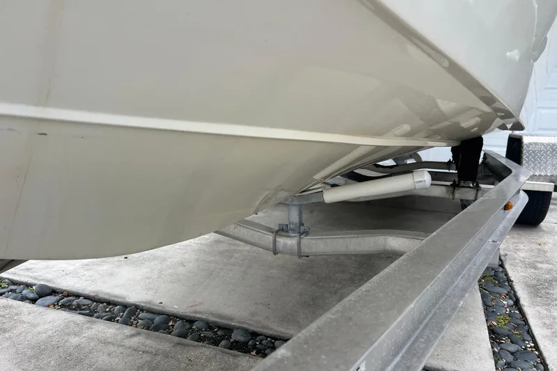 Slide: The Image of 2005 Mako 2101 Inshore boat on trailer, showing hull and trailer details. - 9