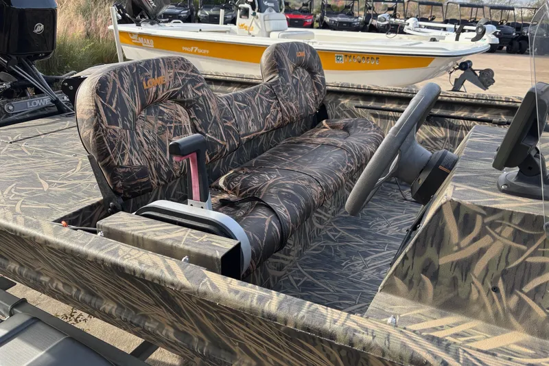 Slide: The Image of 2017 Lowe Roughneck 1860SC boat with camo seats and steering wheel. - 3