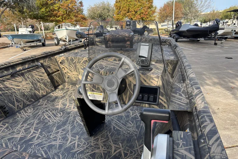 Slide: The Image of 2017 Lowe Roughneck 1860SC boat with camouflage interior and steering console. - 4