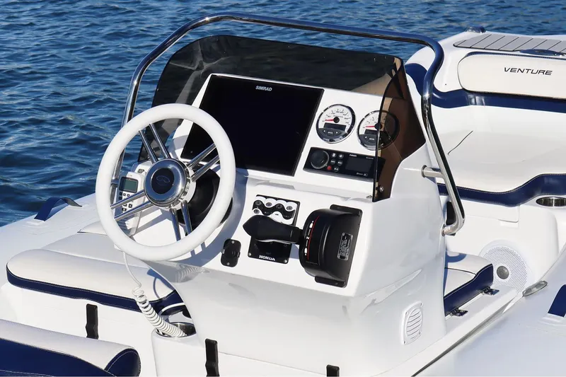 Slide: The Image of Manufacturer Provided Image: Walker Bay Venture 16 boat dashboard, 2025 model, featuring steering wheel and control panel. - 9