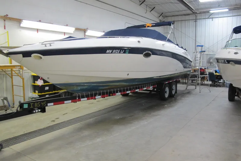 The Image of 1999 Chaparral 2830 SS boat on trailer in indoor storage facility. - 0