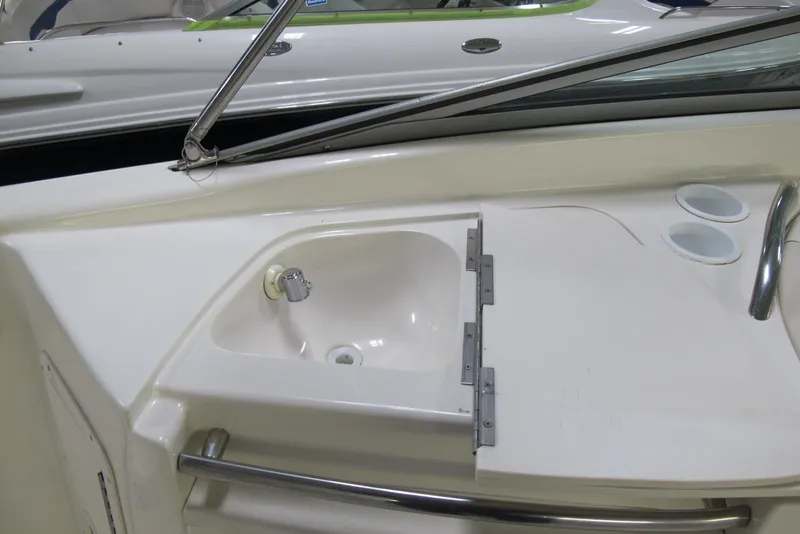 Slide: The Image of 1999 Chaparral 2830 SS boat interior with sink and cup holders. - 6