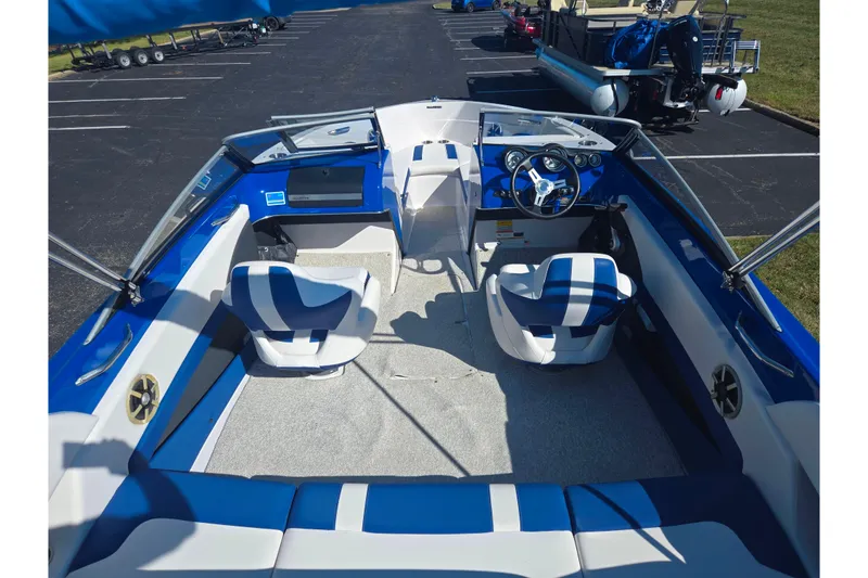 Slide: The Image of 2013 Glastron GT 205 boat interior with blue and white seating, steering wheel, and dashboard. - 11