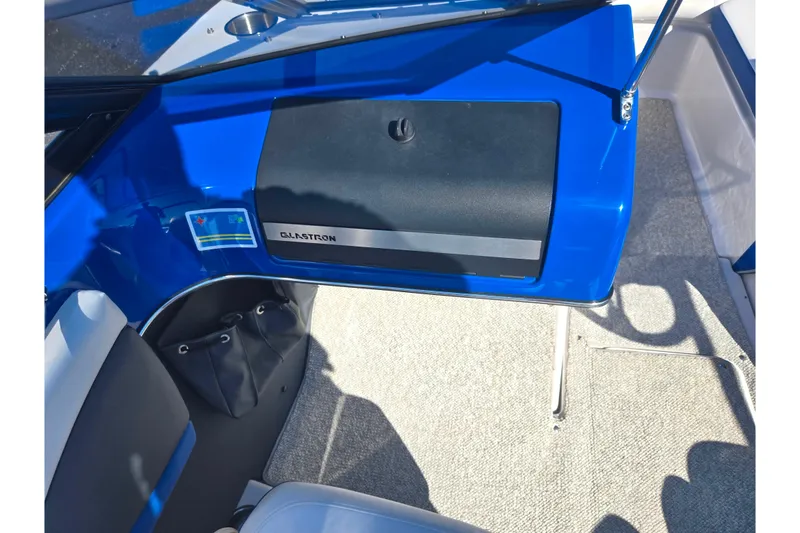 Slide: The Image of 2013 Glastron GT 205 boat interior with blue dashboard and seating. - 16