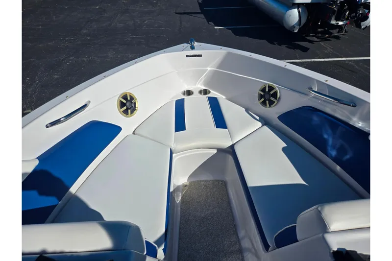 Slide: The Image of 2013 Glastron GT 205 boat interior with blue and white seating. - 18