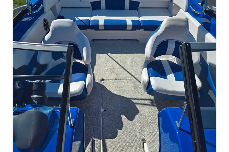 Slide: The Image of 2013 Glastron GT 205 boat interior with blue and white seating arrangement. - 22
