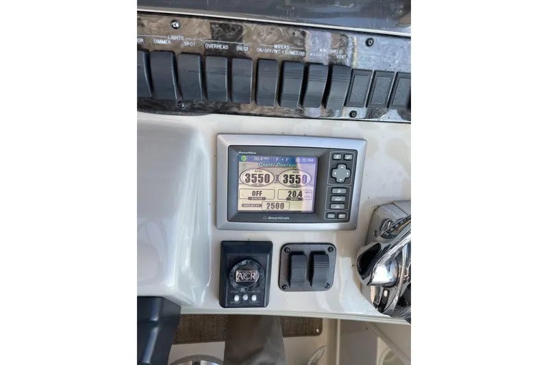 Slide: The Image of Control panel of a 2008 Sea Ray 38 Sundancer boat with digital display and switches. - 8