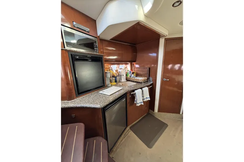 Slide: The Image of Interior of 2008 Sea Ray 38 Sundancer yacht kitchen with modern appliances. - 9