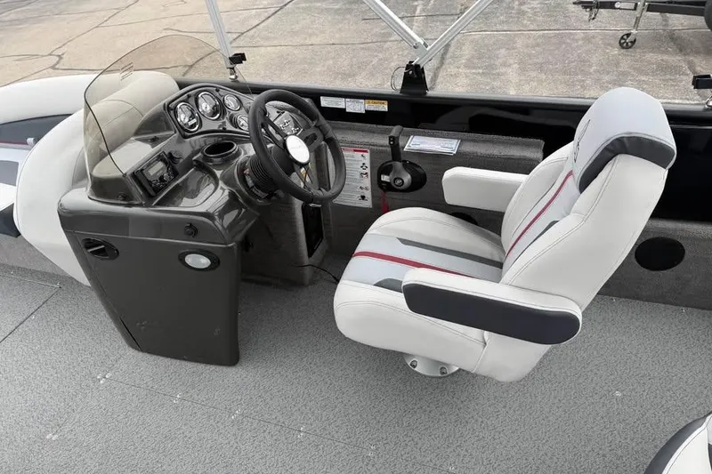Slide: The Image of 2026 Lowe Sport Deck 224 boat cockpit with steering wheel and captain's chair. - 11