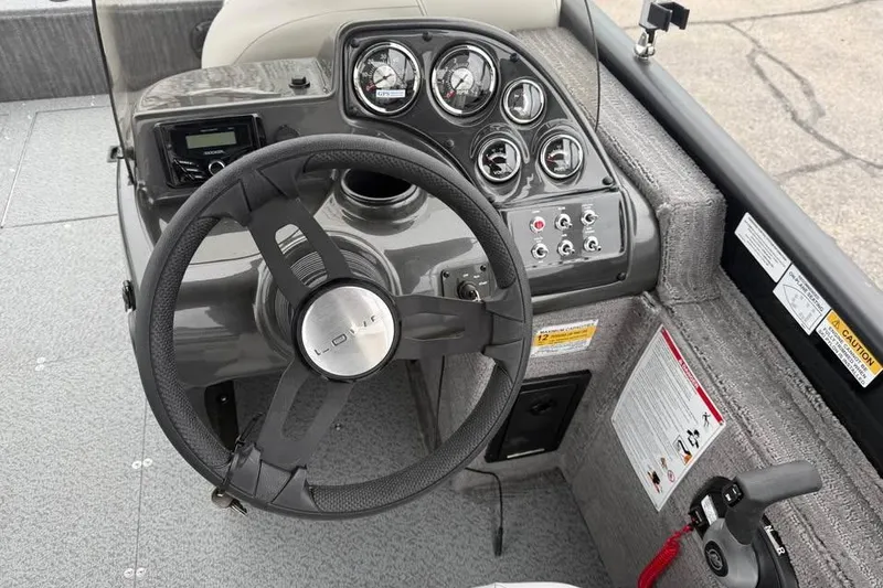 Slide: The Image of Steering console of 2026 Lowe Sport Deck 224 boat with gauges and controls. - 12