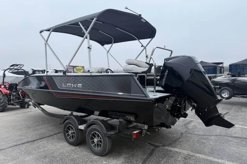 Slide: The Image of 2026 Lowe Sport Deck 224 boat with canopy and outboard motor on trailer. - 6