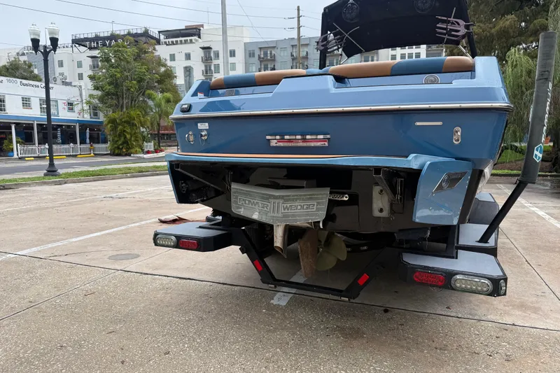 Slide: The Image of 2021 Axis T23 boat on trailer, parked in urban area, rear view. - 10