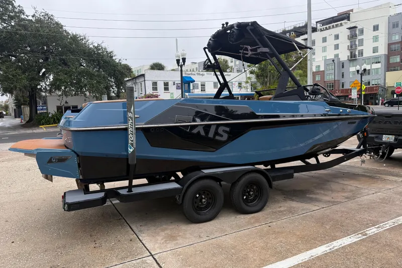 Slide: The Image of 2021 Axis T23 boat on trailer, parked in urban setting. - 9