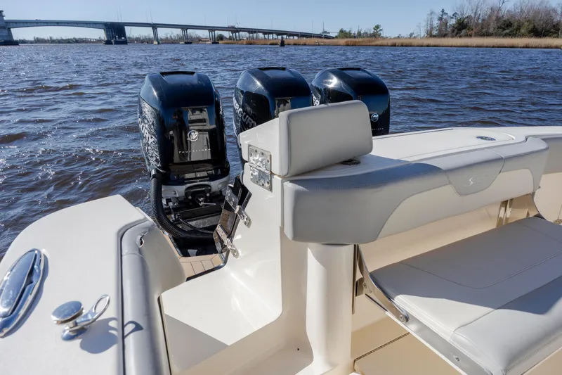 Slide: The Image of 2019 Scout 355 LXF boat with triple Mercury engines on a sunny day. - 14