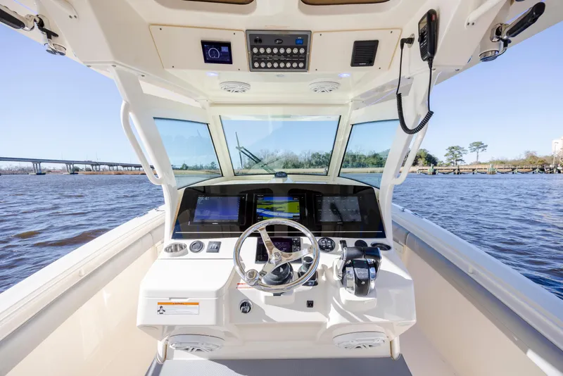 Slide: The Image of 2019 Scout 355 LXF boat cockpit with advanced navigation system on open water. - 23