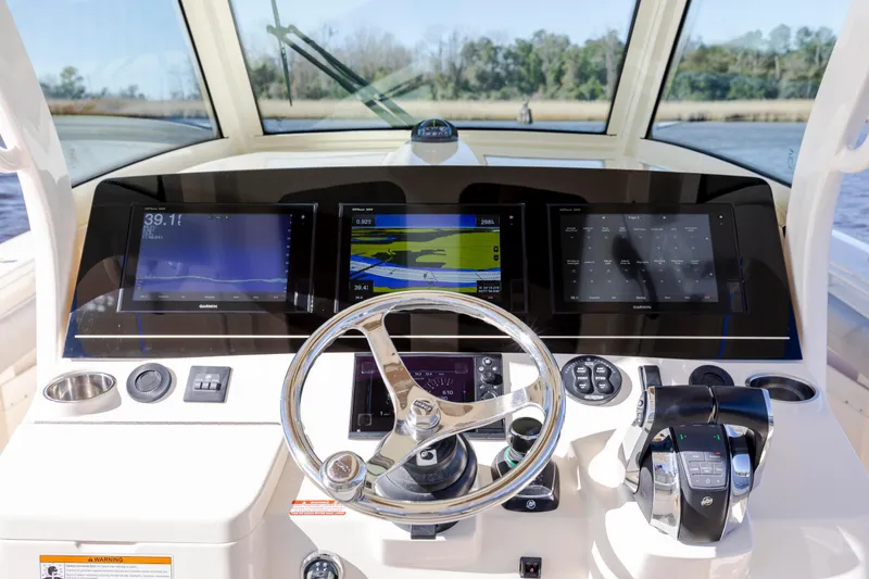 Slide: The Image of 2019 Scout 355 LXF boat dashboard with advanced navigation displays and controls. - 24