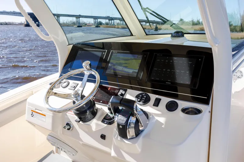 Slide: The Image of 2019 Scout 355 LXF boat helm with modern navigation displays and controls. - 25