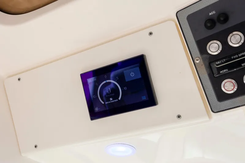 Slide: The Image of Control panel of 2019 Scout 355 LXF boat featuring Seakeeper display. - 27