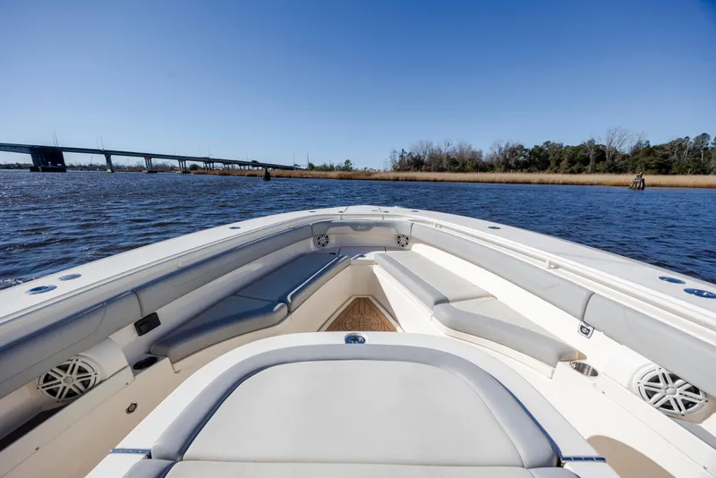 Slide: The Image of 2019 Scout 355 LXF boat interior with scenic water and bridge view. - 29